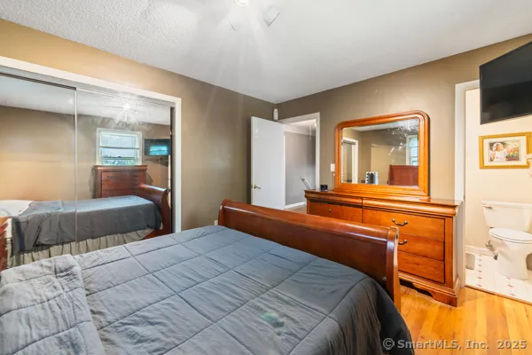 a bedroom with a large bed and a tv