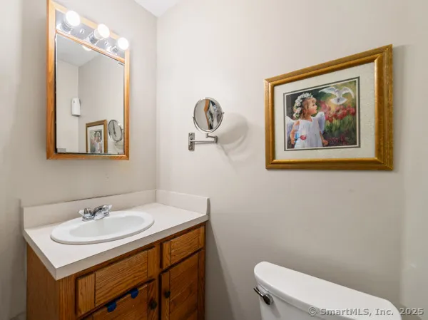 a bathroom with a sink mirror and toilet