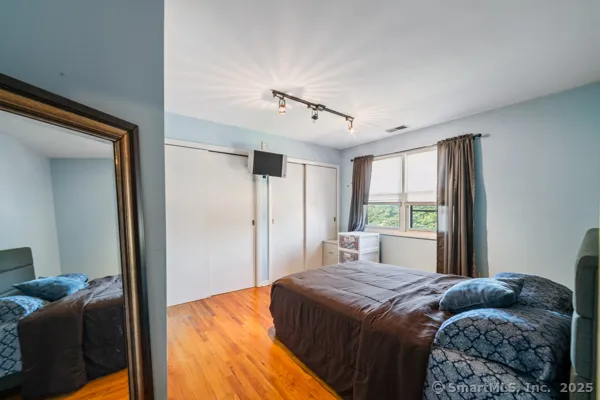 a bedroom with a bed and window