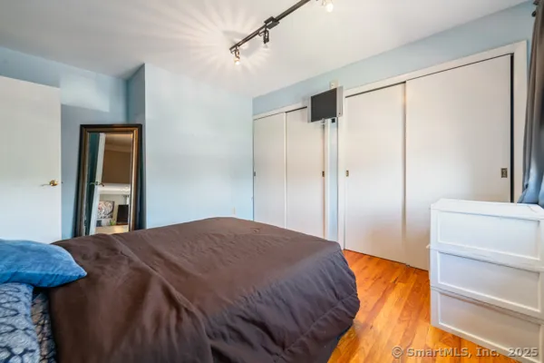 a bedroom with a bed and a dresser