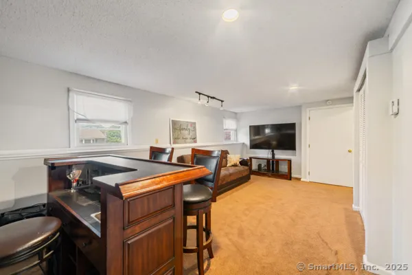 a view of a livingroom with furniture and a flat screen tv