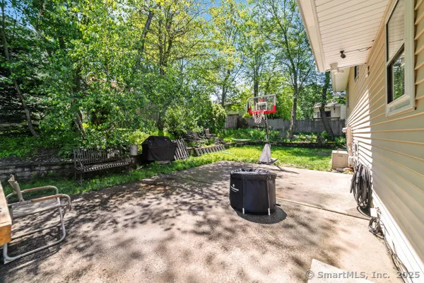 a view of potted plants in backyard of a house