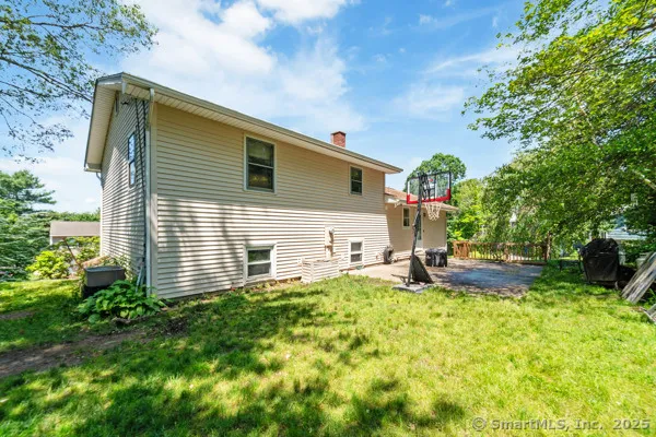 a view of a house with backyard and sitting area