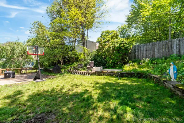 a view of backyard with swimming pool and sitting area