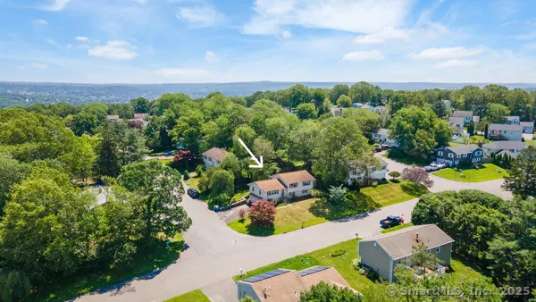 an aerial view of multiple houses with yard