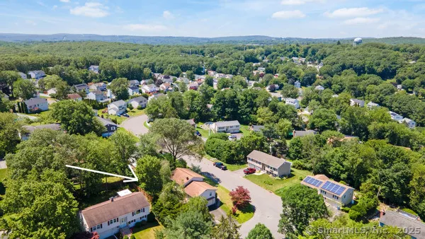 an aerial view of a houses with a yard