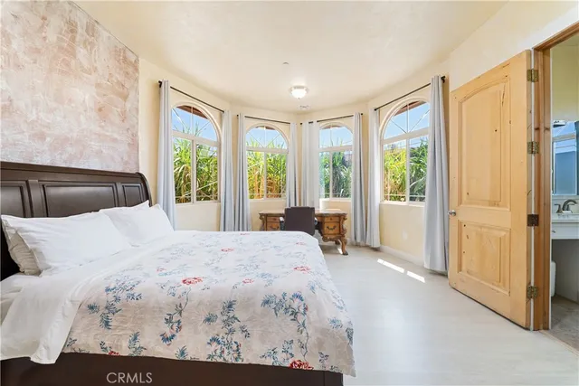 a bedroom with a bed and a couch with window