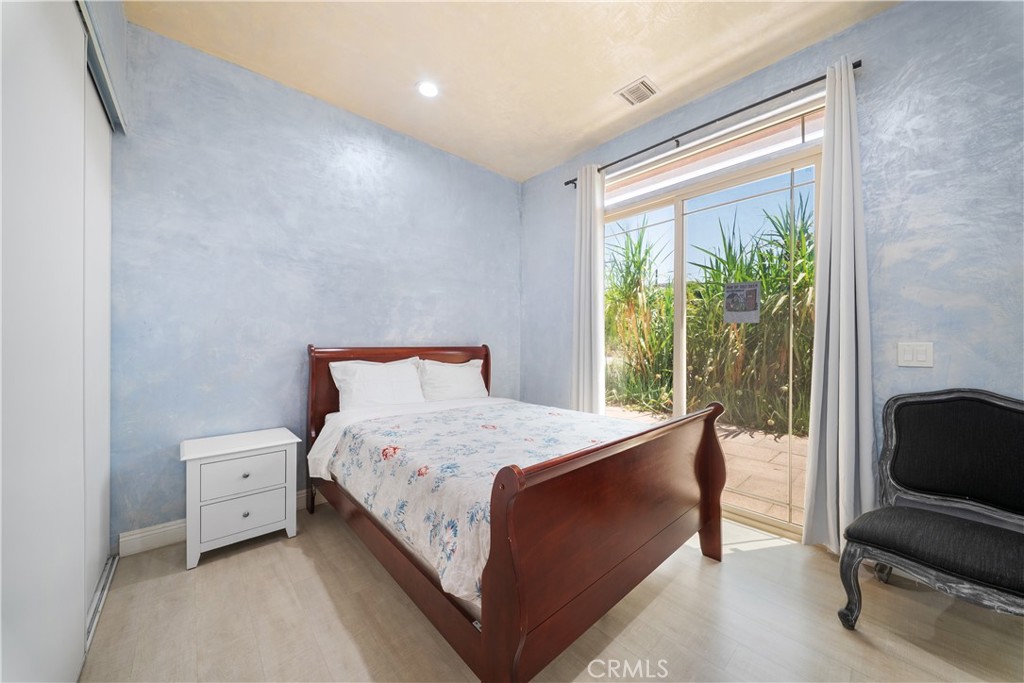 12605 Kagel Canyon Road Sylmar, CA 91342 - Photo 24 of 61 a bedroom with a bed a chair and a large window
