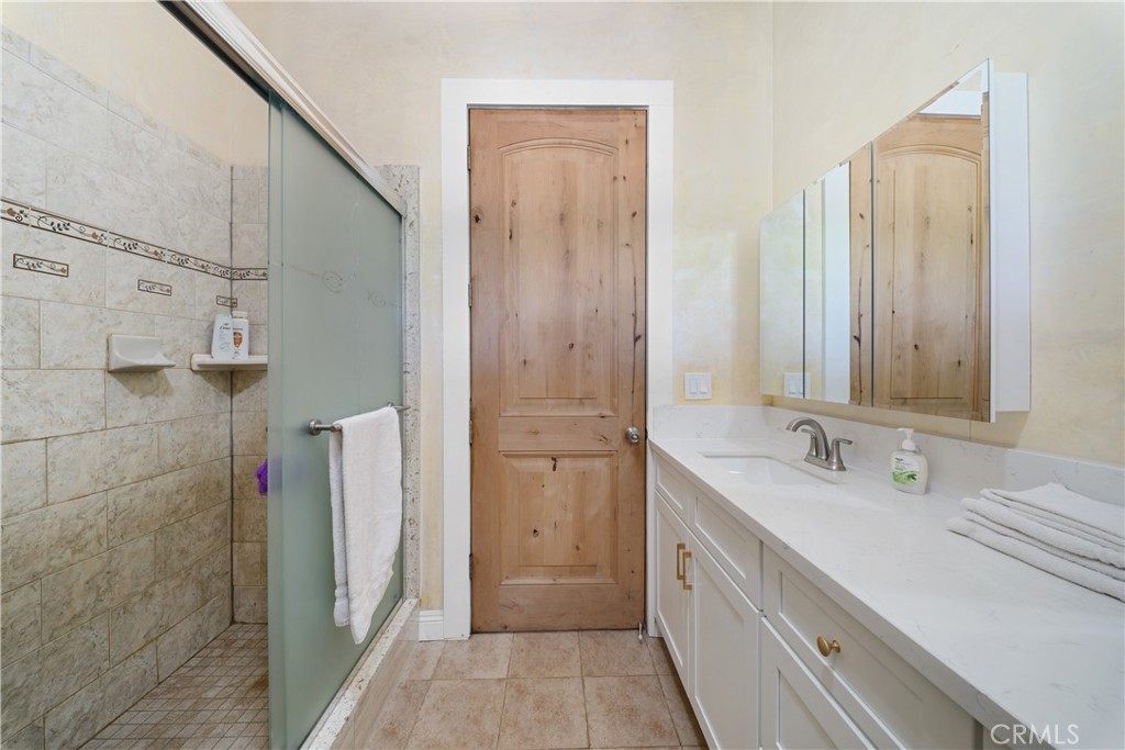12605 Kagel Canyon Road Sylmar, CA 91342 - Photo 26 of 61 a bathroom with a double vanity sink and a mirror