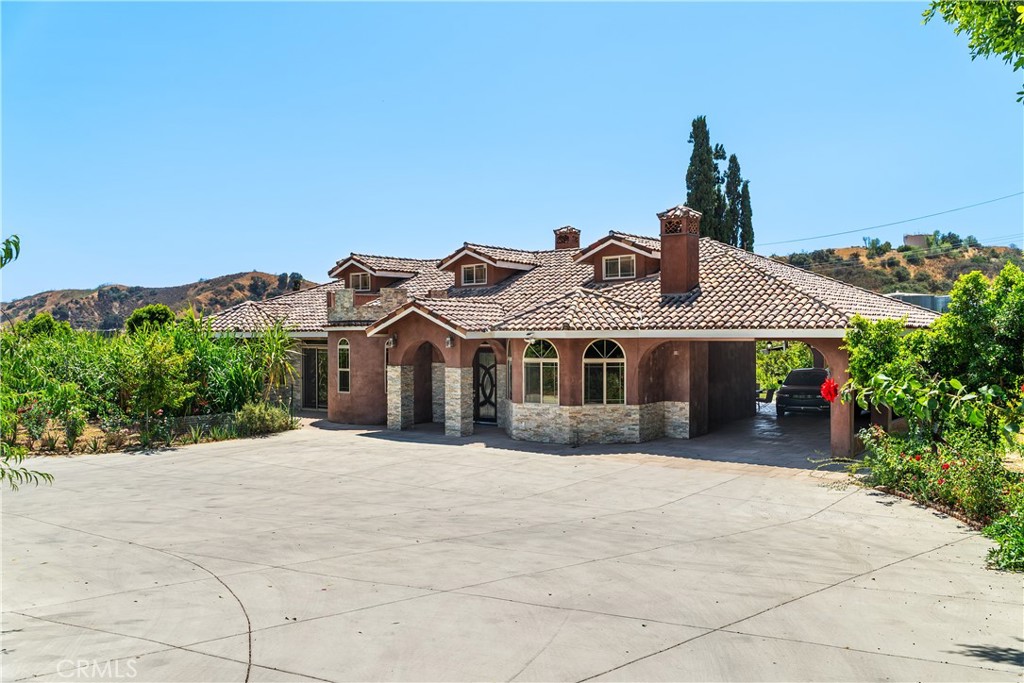 12605 Kagel Canyon Road Sylmar, CA 91342 - Photo 3 of 61 a front view of a house with a garden