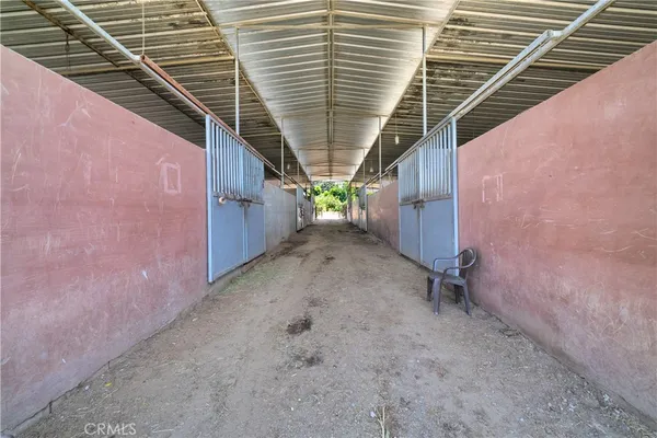 a view of a dirt road with a building in the background