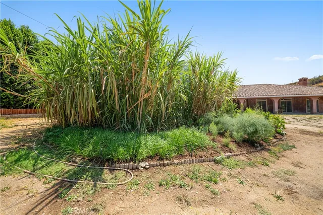 a view of a balcony with a red door and a porch