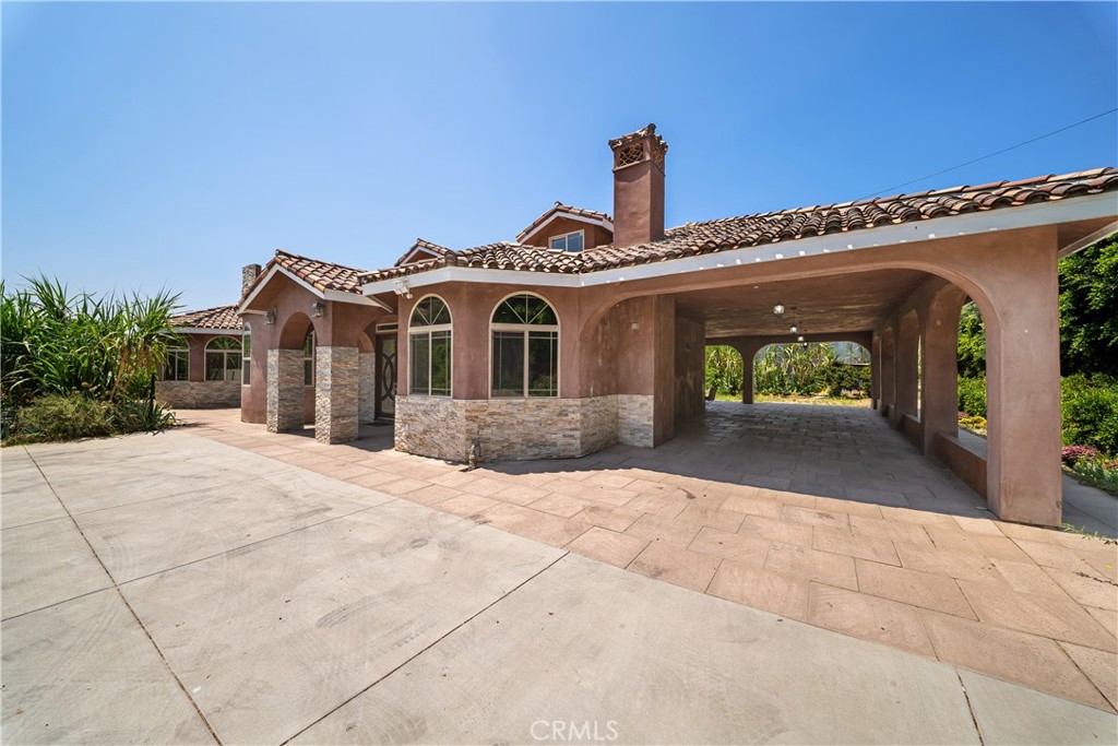 12605 Kagel Canyon Road Sylmar, CA 91342 - Photo 4 of 61 a front view of a house with a yard and garage