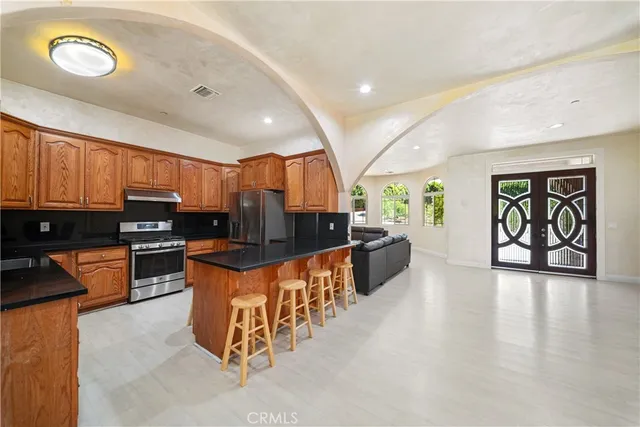 a large kitchen with lots of counter space and chairs