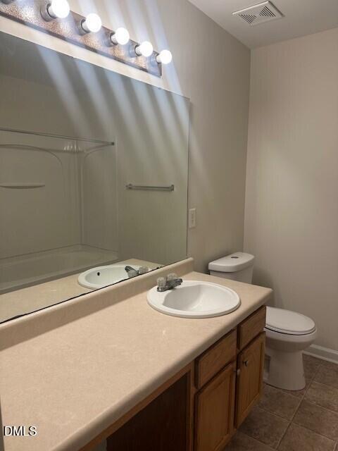 6005 Namozine Court Raleigh, NC 27610 - Photo 17 of 24 a bathroom with a sink a toilet and a mirror