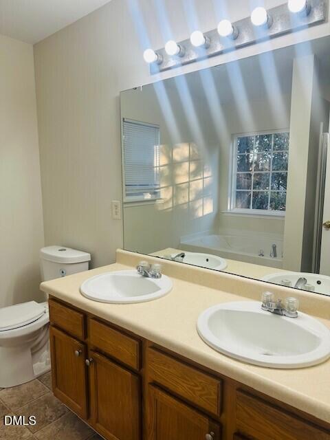 6005 Namozine Court Raleigh, NC 27610 - Photo 23 of 24 a bathroom with a sink a toilet and a mirror
