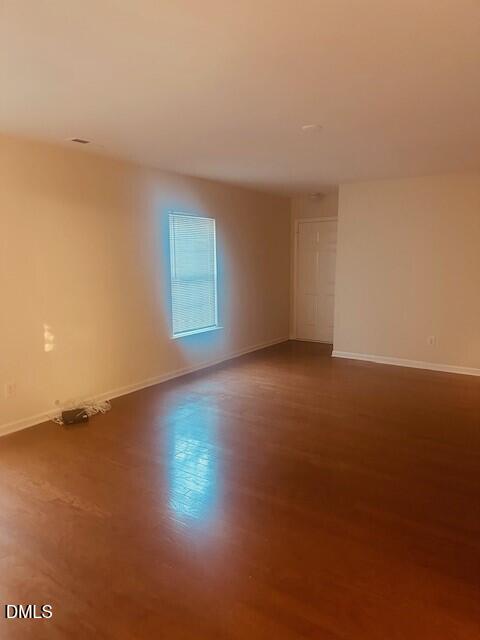 6005 Namozine Court Raleigh, NC 27610 - Photo 3 of 24 an empty room with wooden floor and windows