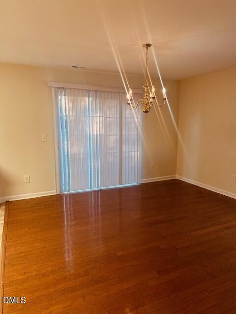 6005 Namozine Court Raleigh, NC 27610 - Photo 4 of 24 a view of an empty room with wooden floor