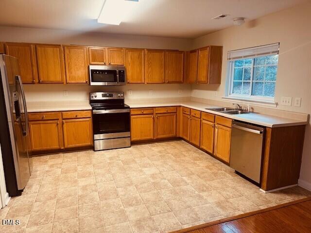 6005 Namozine Court Raleigh, NC 27610 - Photo 5 of 24 a kitchen with stainless steel appliances granite countertop a stove top oven a sink dishwasher and a refrigerator