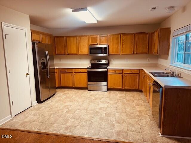 6005 Namozine Court Raleigh, NC 27610 - Photo 6 of 24 a kitchen with stainless steel appliances granite countertop a refrigerator stove and sink