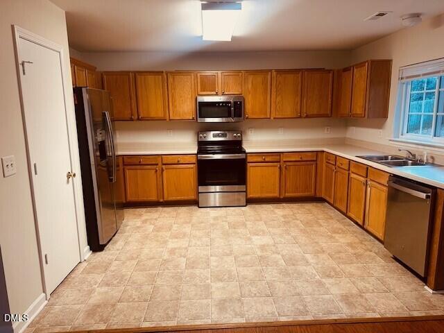 6005 Namozine Court Raleigh, NC 27610 - Photo 7 of 24 a kitchen with granite countertop a refrigerator stove top oven and sink