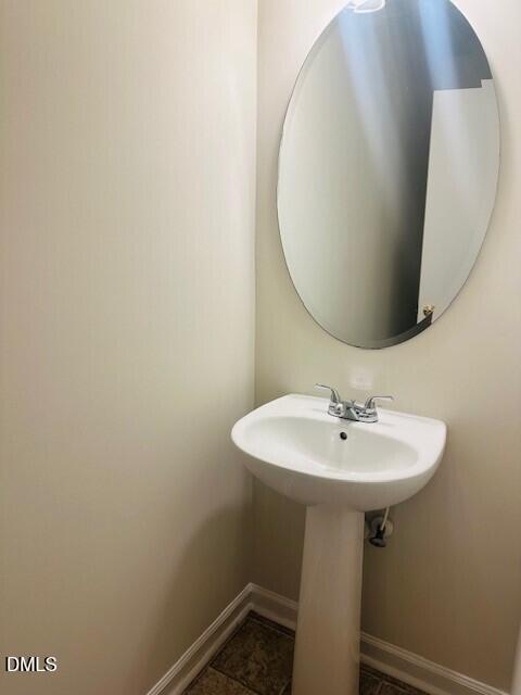 6005 Namozine Court Raleigh, NC 27610 - Photo 8 of 24 a bathroom with a sink a mirror and vanity