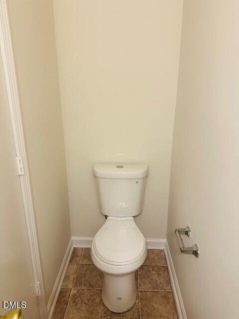 6005 Namozine Court Raleigh, NC 27610 - Photo 9 of 24 a white toilet sitting next to a white wall