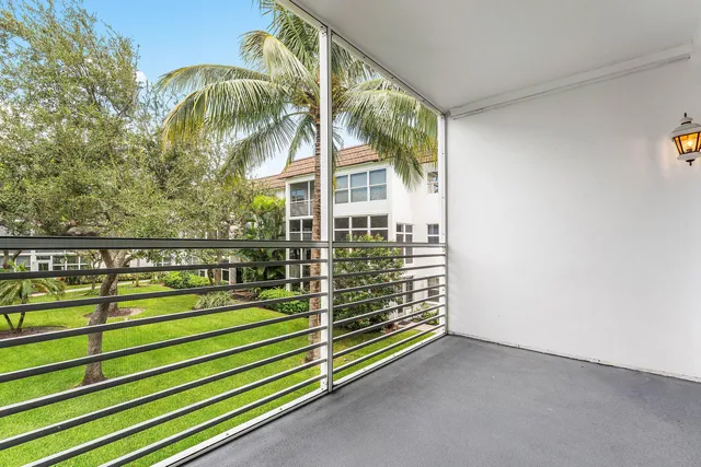 a view of house with garden and tall tress