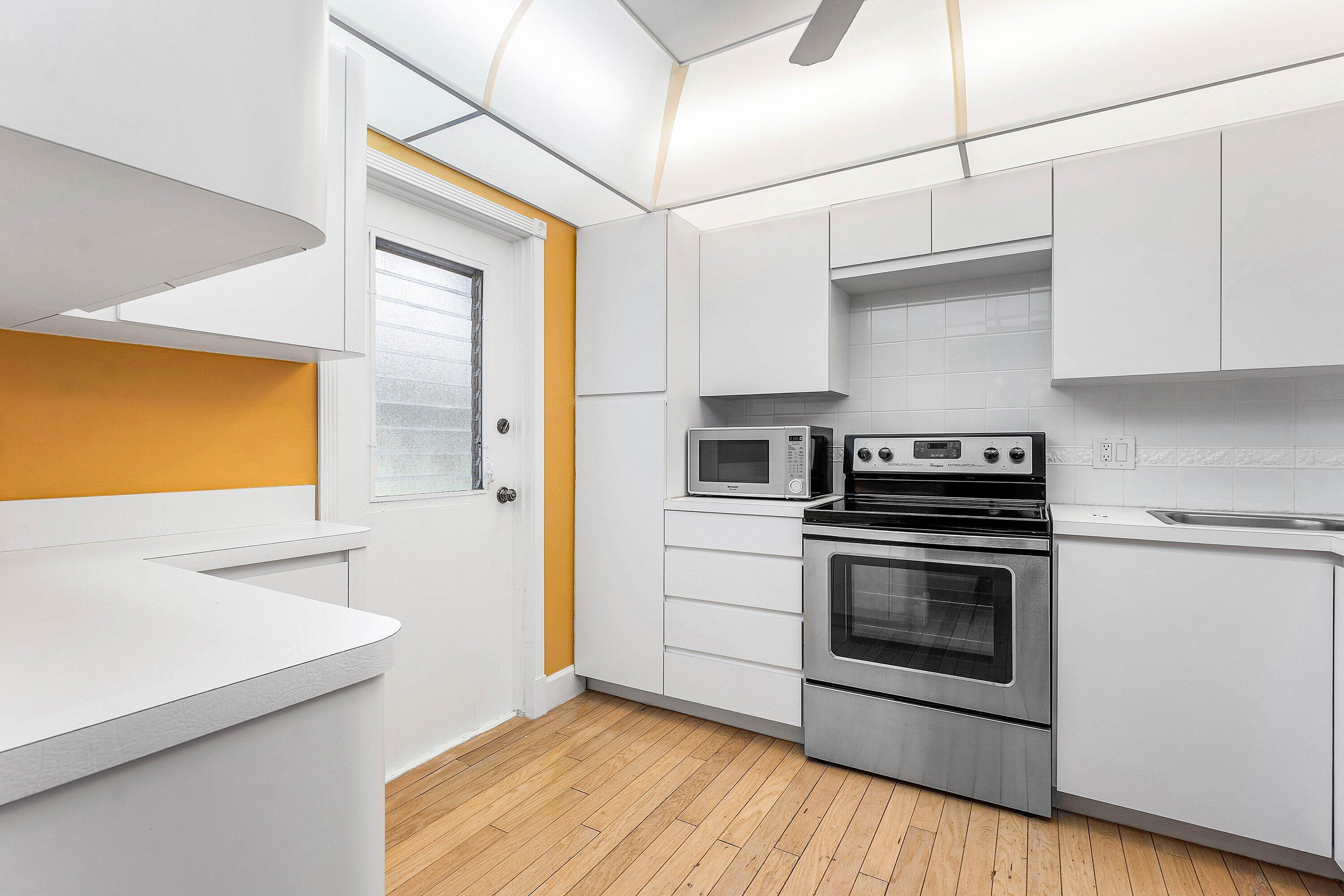 1501 South Ocean Boulevard, Unit 225 Lauderdale-by-the-Sea, FL 33062 - Photo 20 of 47 a kitchen with stainless steel appliances a stove a sink and a refrigerator