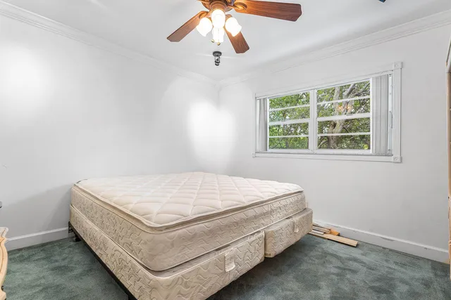 a bed sitting in a room next to a window