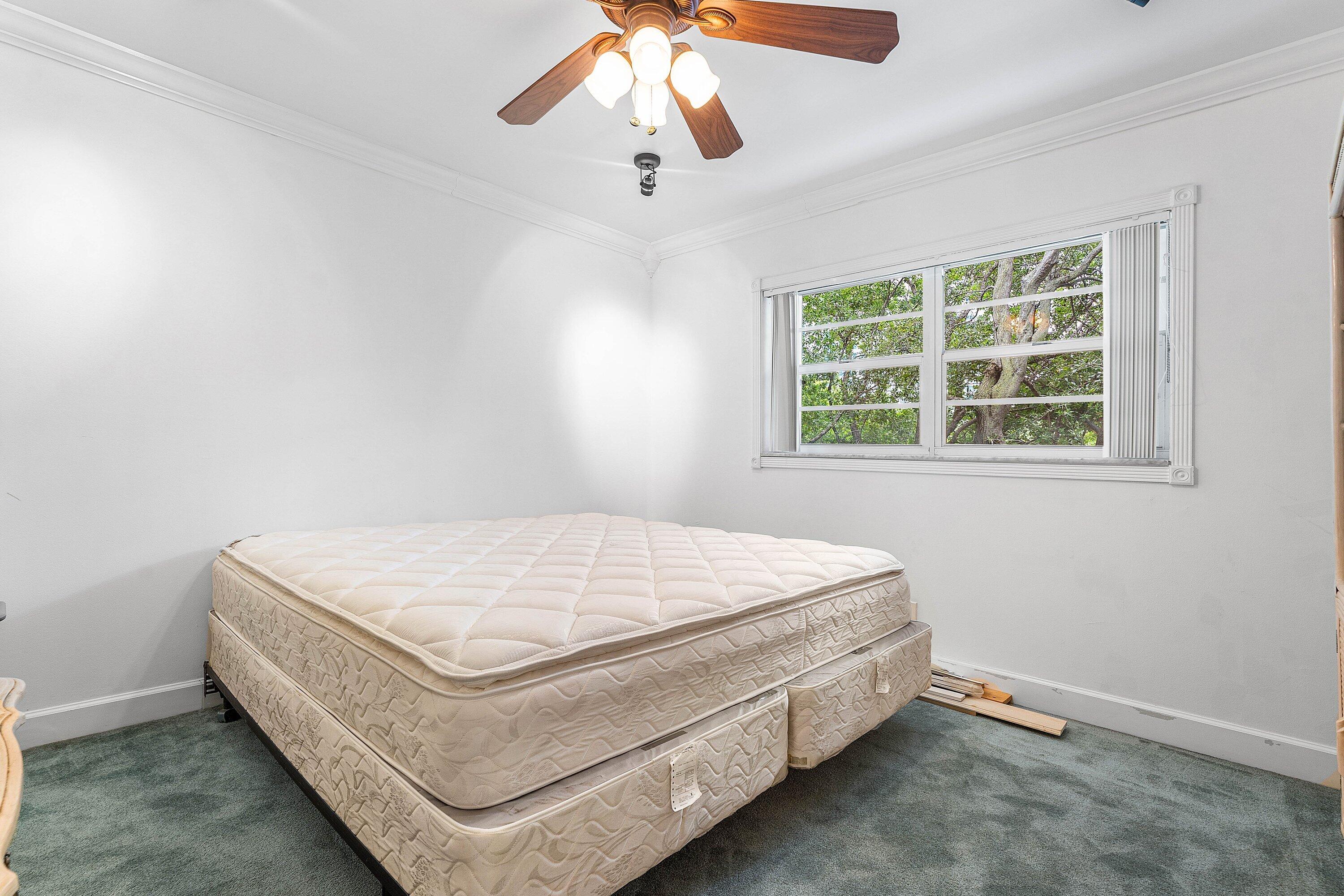 1501 South Ocean Boulevard, Unit 225 Lauderdale-by-the-Sea, FL 33062 - Photo 22 of 47 a bed sitting in a bedroom next to a window