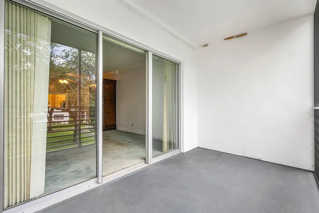 a view of a patio with a table and chairs