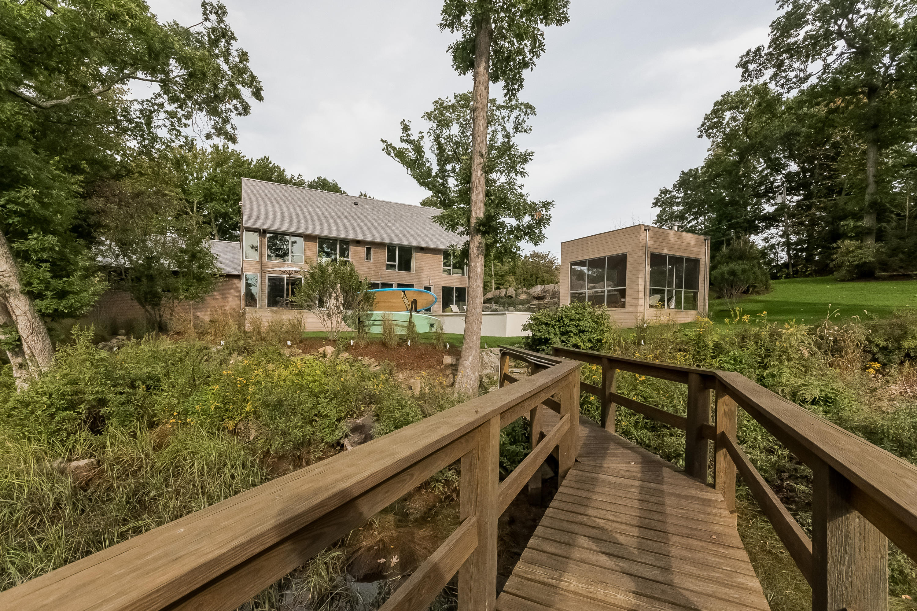 1 Beverly Place Darien, CT 06820 - Photo 41 of 45 a view of a house with wooden deck and a garden