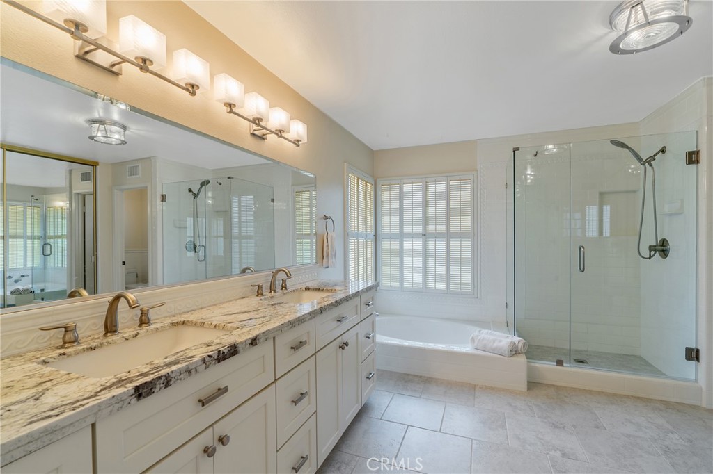 11422 Ridgegate Drive Whittier, CA 90601 - Photo 11 of 18 a spacious bathroom with a granite countertop tub sink shower and a mirror