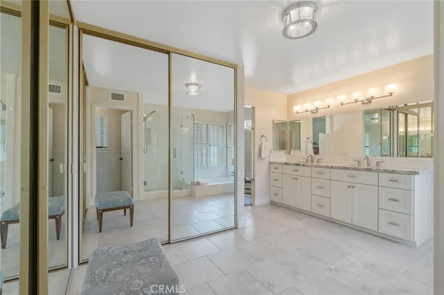 a bathroom with a granite countertop sink a toilet and a shower