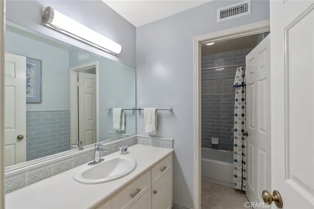 a bathroom with a sink double vanity and shower