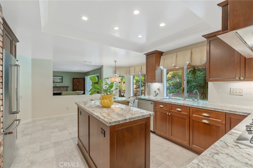11422 Ridgegate Drive Whittier, CA 90601 - Photo 7 of 18 a kitchen with kitchen island granite countertop a sink and counter top space