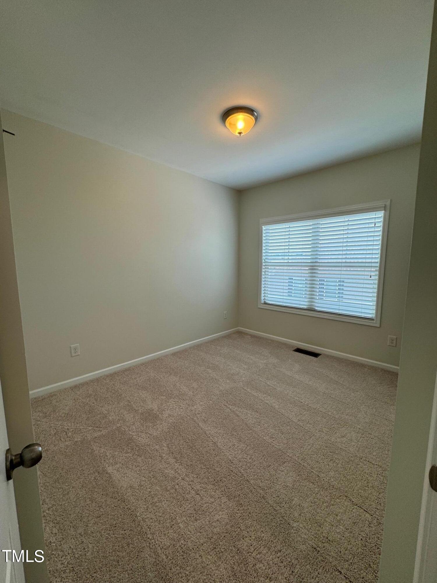 1571 Rodessa Run Raleigh, NC 27607 - Photo 22 of 25 an empty room with a empty space and window