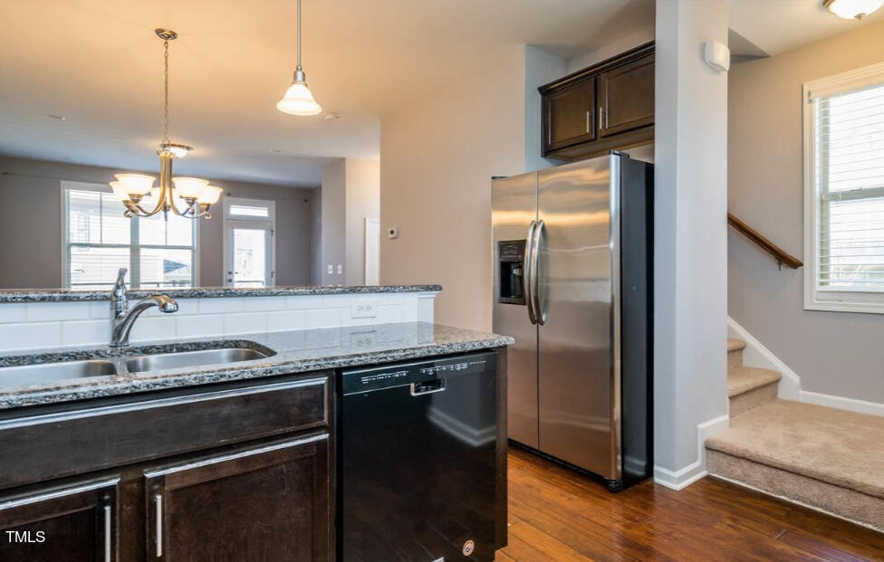 1571 Rodessa Run Raleigh, NC 27607 - Photo 5 of 25 a kitchen with stainless steel appliances granite countertop a refrigerator a sink and a stove