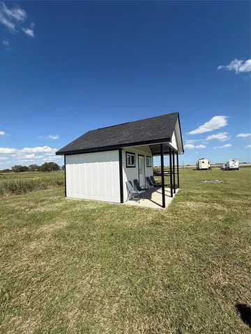 a view of a house with backyard and sitting area