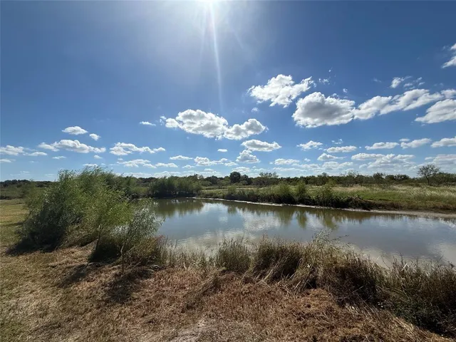 a view of a lake in middle of forest