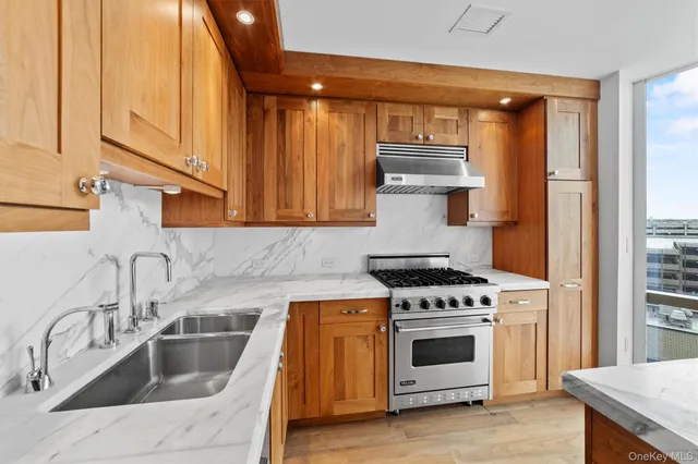 a kitchen with white cabinets and appliances