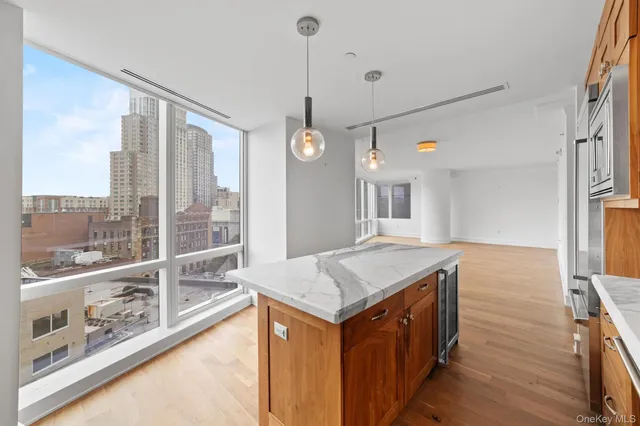 a kitchen that has a lot of windows and wooden floor