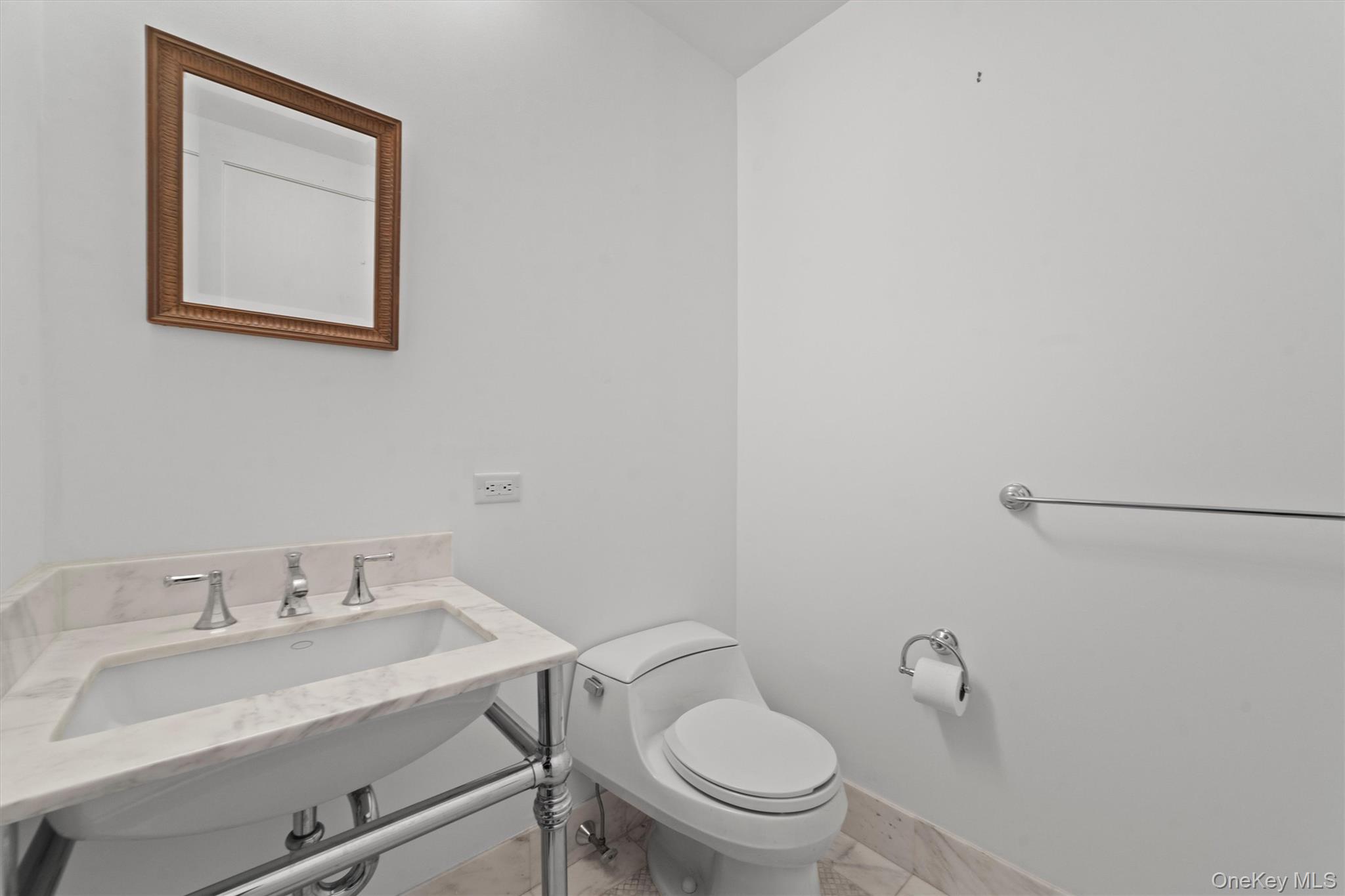 5 Renaissance Square, Unit 10G White Plains, NY 10601 - Photo 15 of 28 a bathroom with a sink and a toilet