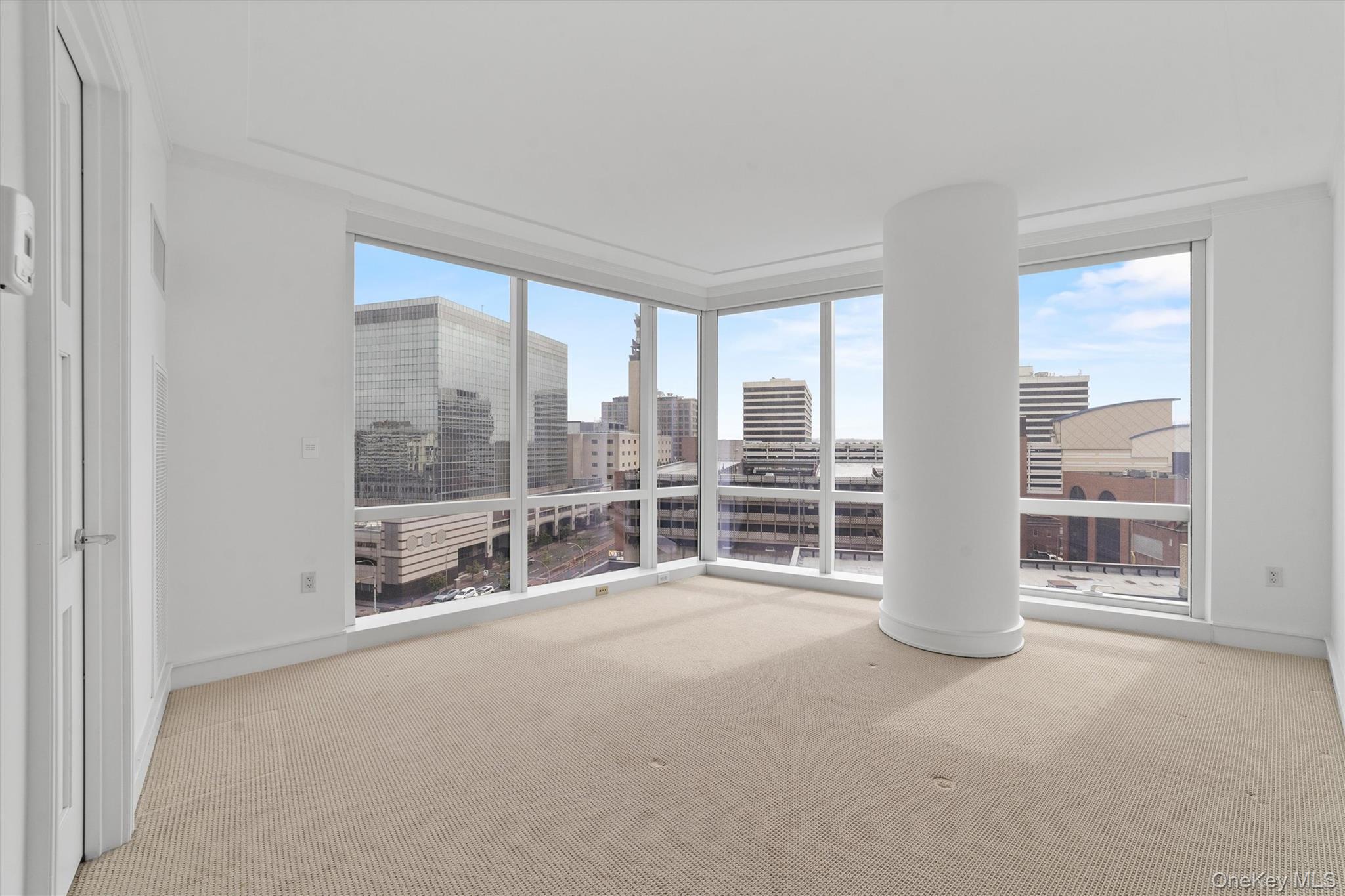5 Renaissance Square, Unit 10G White Plains, NY 10601 - Photo 16 of 28 an empty room with floor to ceiling windows and pool