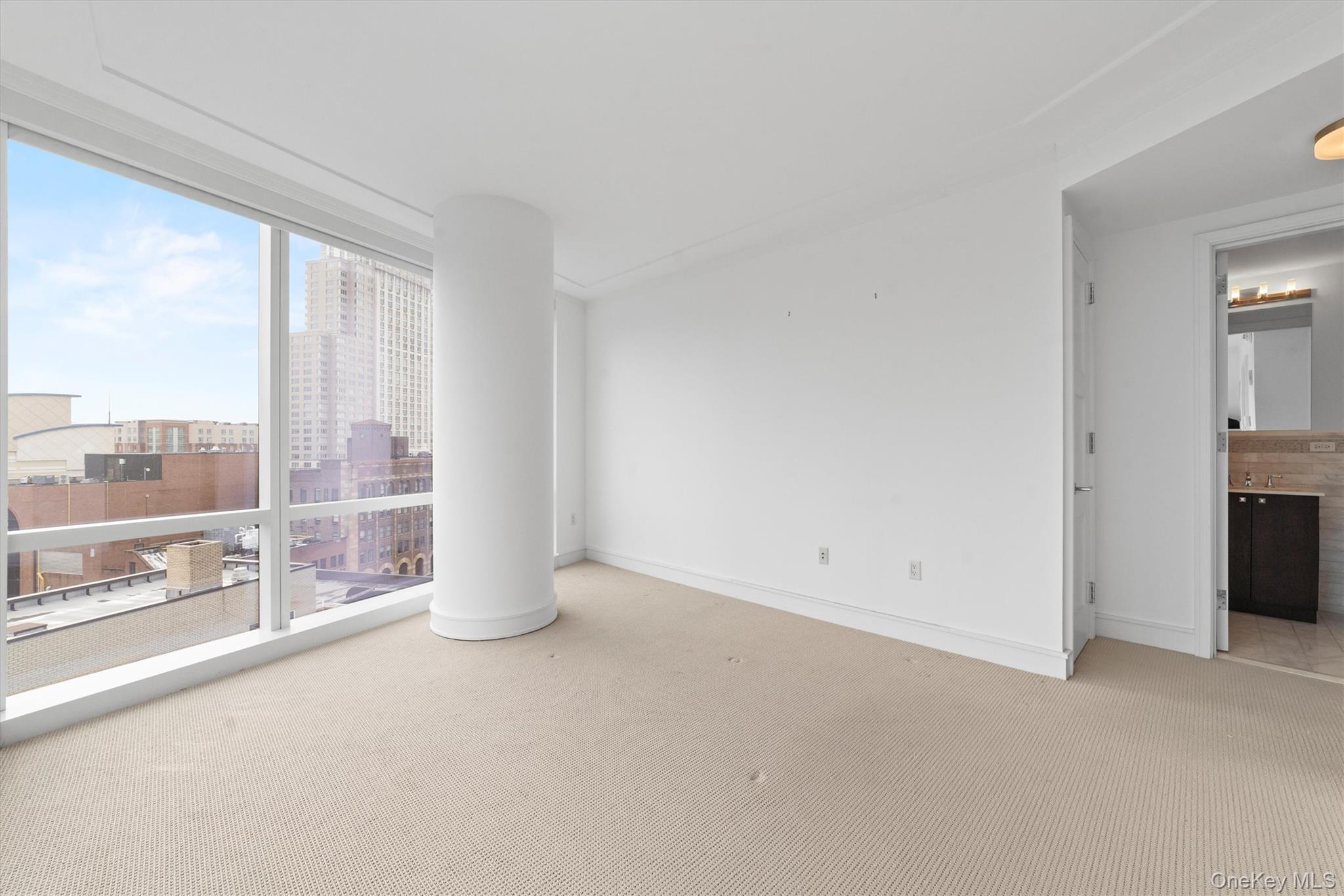 5 Renaissance Square, Unit 10G White Plains, NY 10601 - Photo 20 of 28 en empty room with large windows and city view