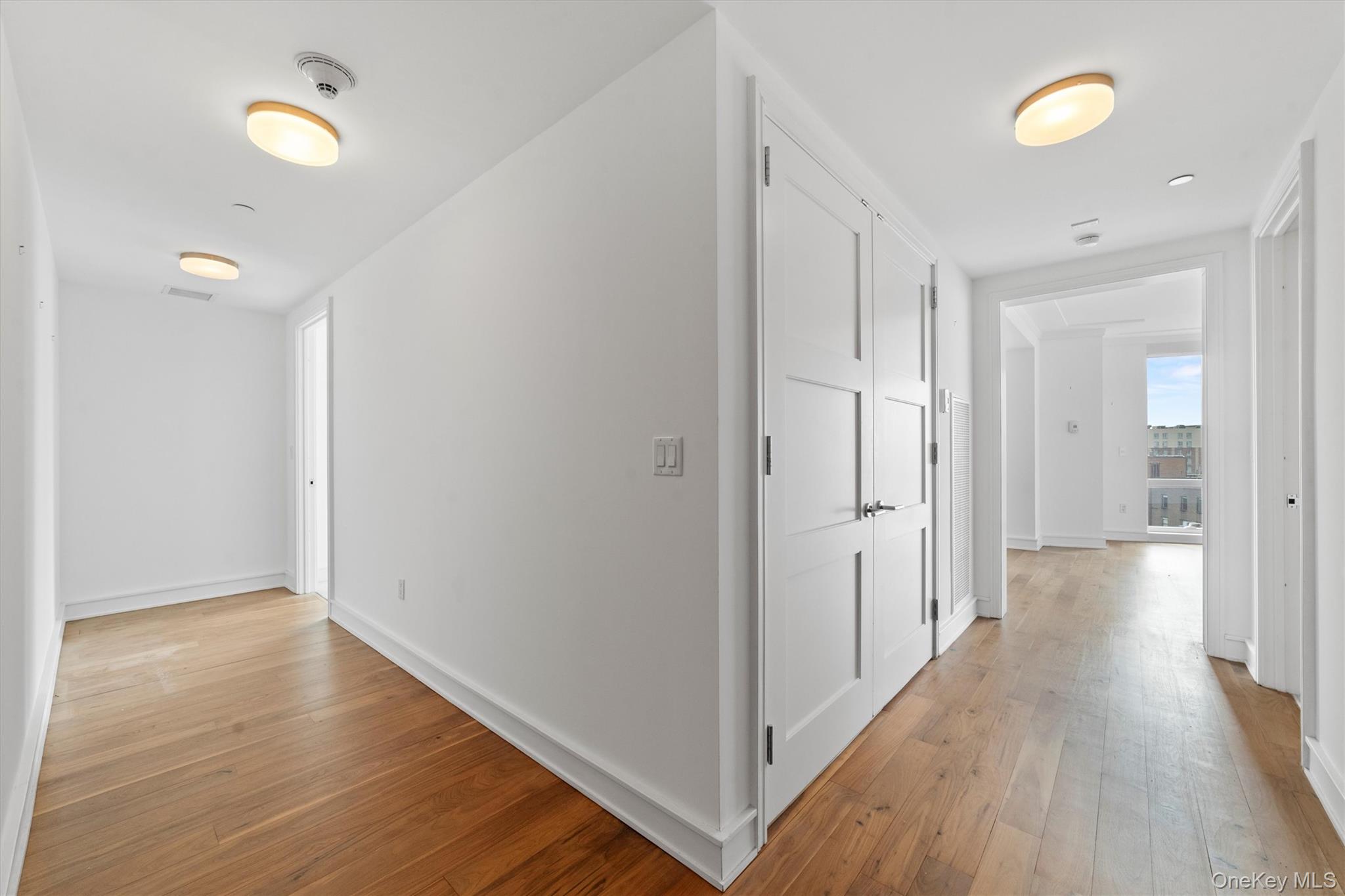 5 Renaissance Square, Unit 10G White Plains, NY 10601 - Photo 2 of 28 a view of a hallway with wooden floor