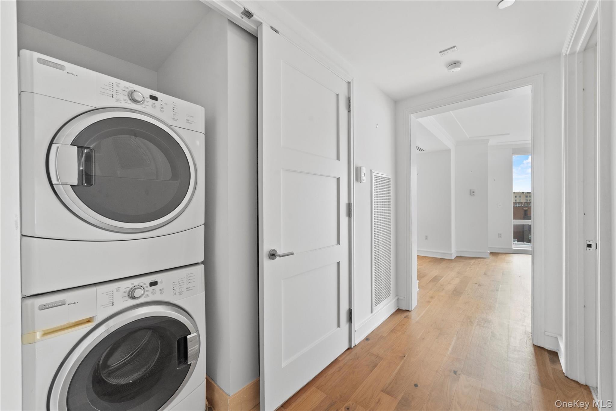 5 Renaissance Square, Unit 10G White Plains, NY 10601 - Photo 23 of 28 a view of a hallway with washer and dryer