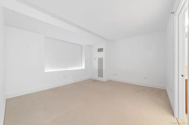 an empty room with a empty space and windows