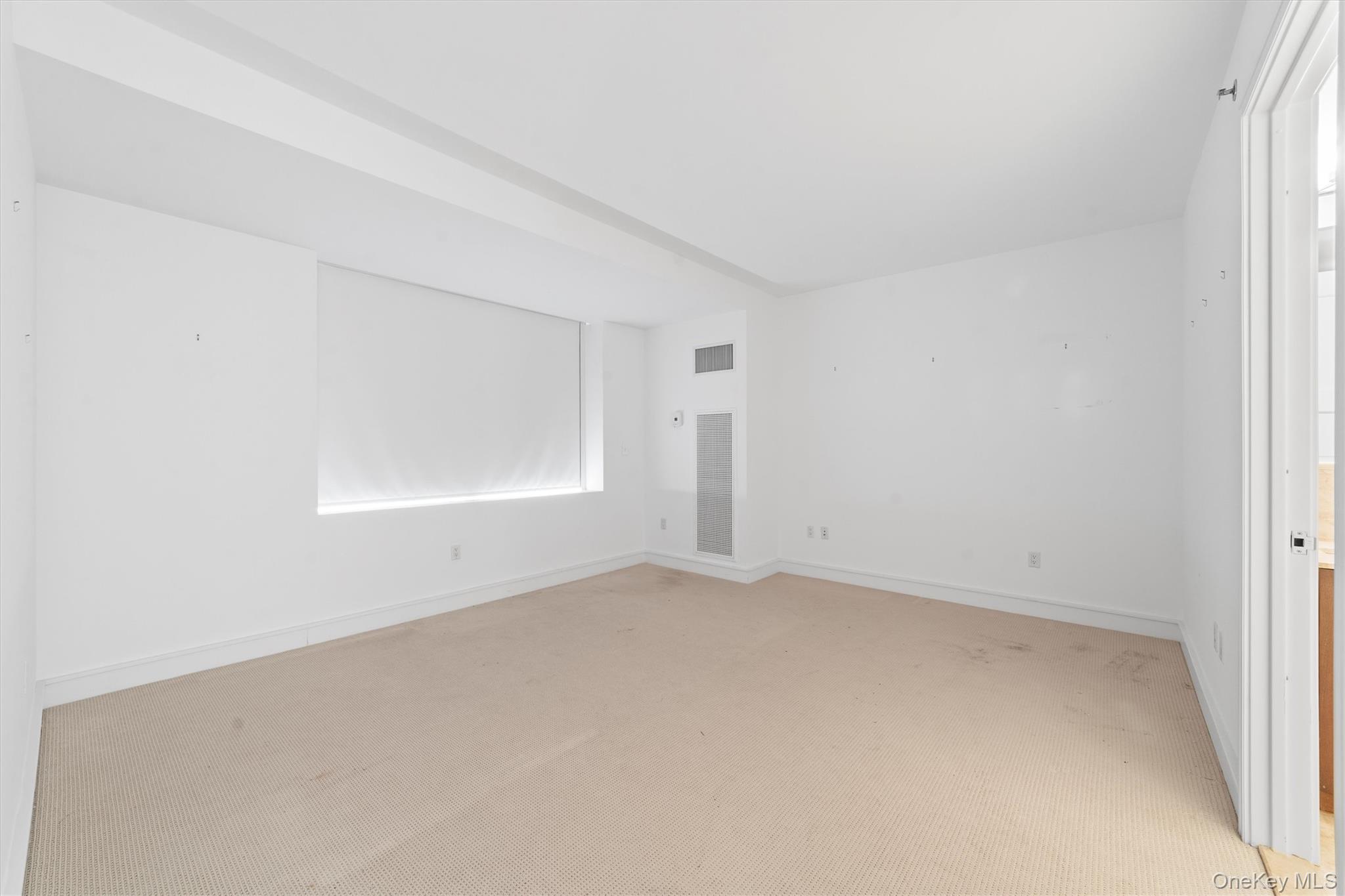 5 Renaissance Square, Unit 10G White Plains, NY 10601 - Photo 24 of 28 an empty room with a empty space and windows